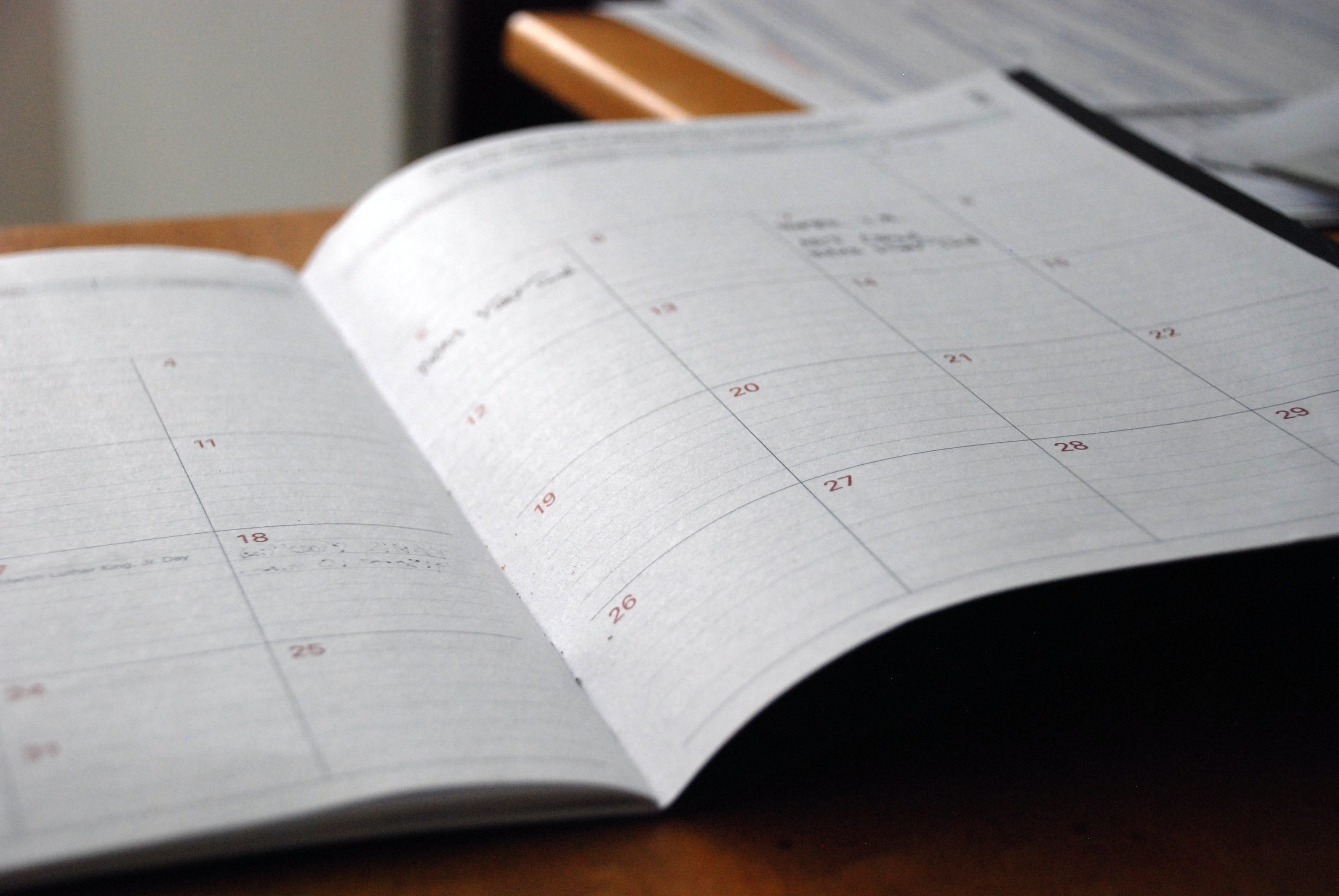 Closeup of monthly calendar, content illegible