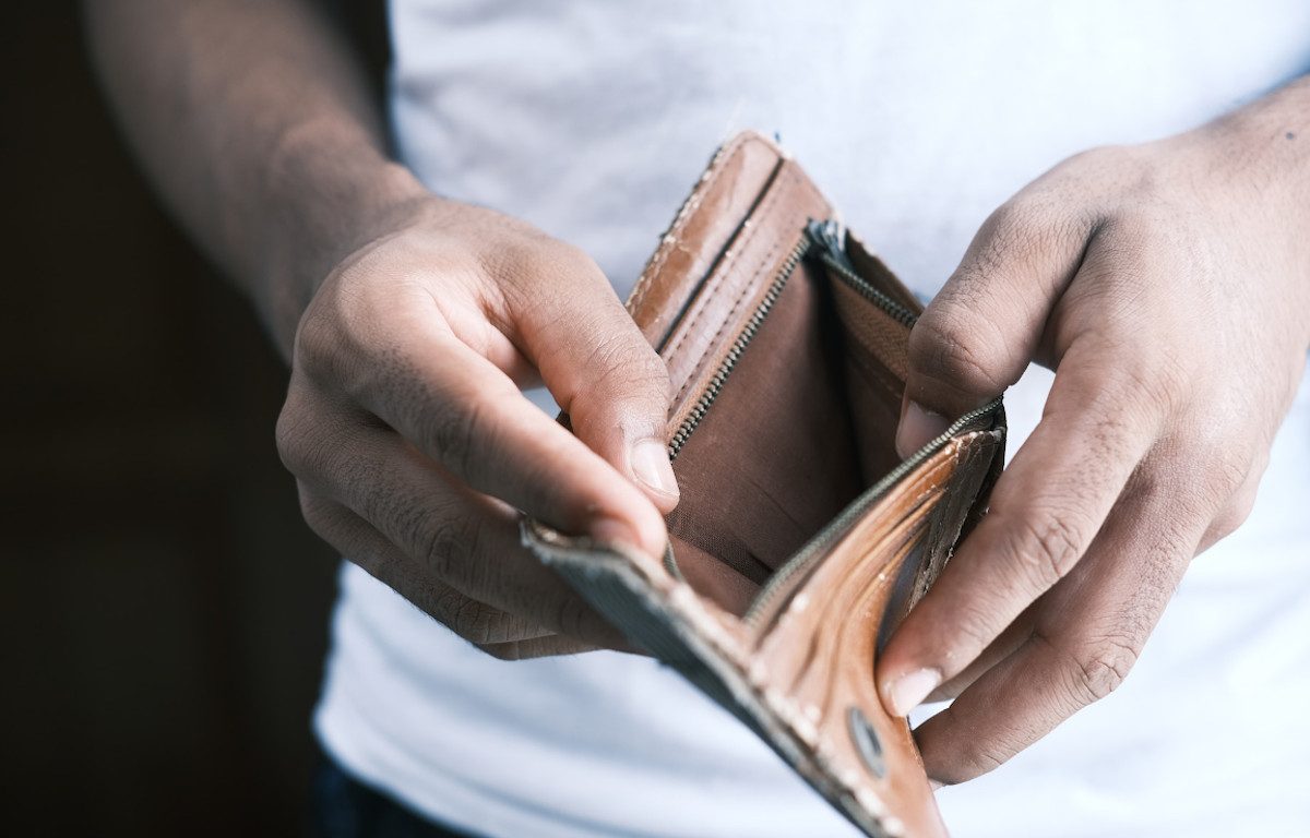 Man holding open an empty wallet.