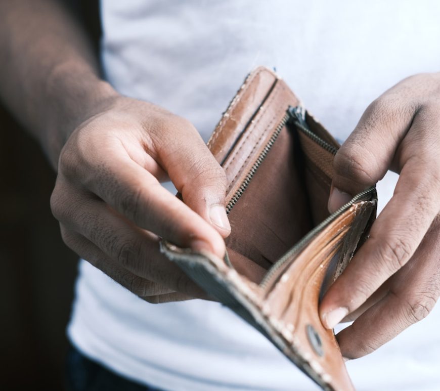 Man holding open an empty wallet.