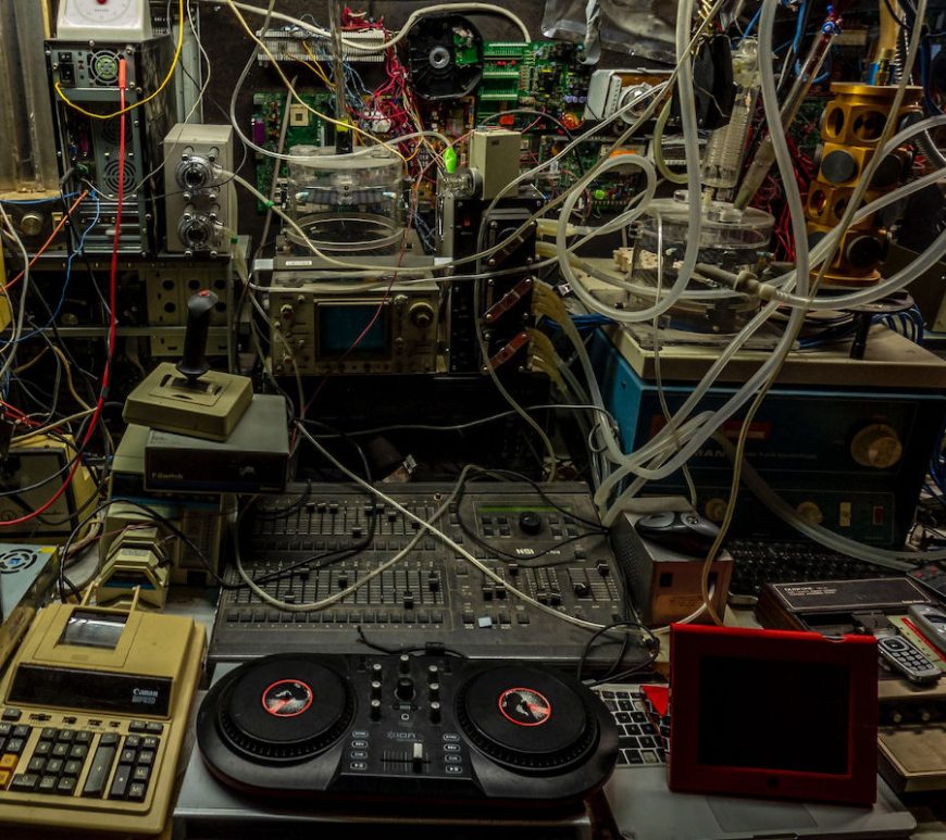 Clutter pile of old electronics and wires.