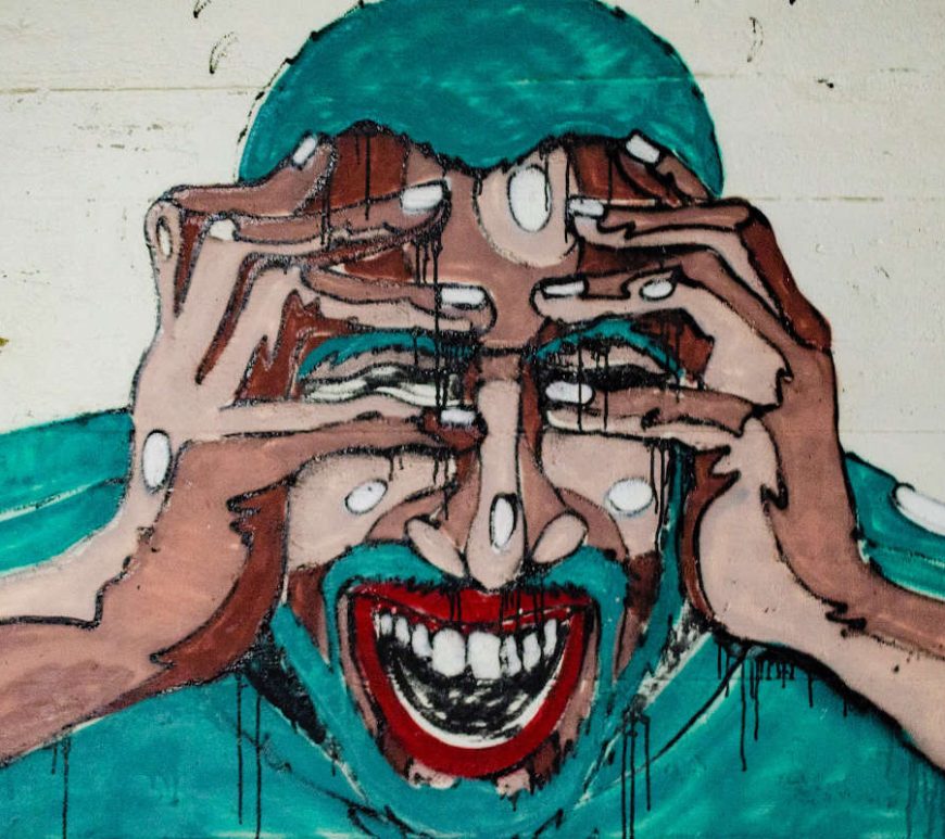 Graffiti image of man triggered with an emotional reaction, grabbing his head with his hands.