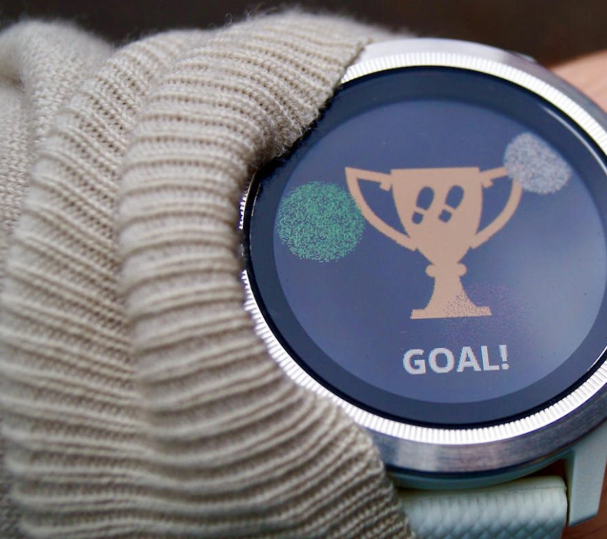 Wristwatch with trophy icon of steps goal reached.