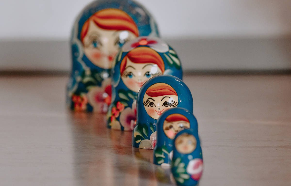 Five blue Matryoshka dolls, also known as stacking or nesting dolls.