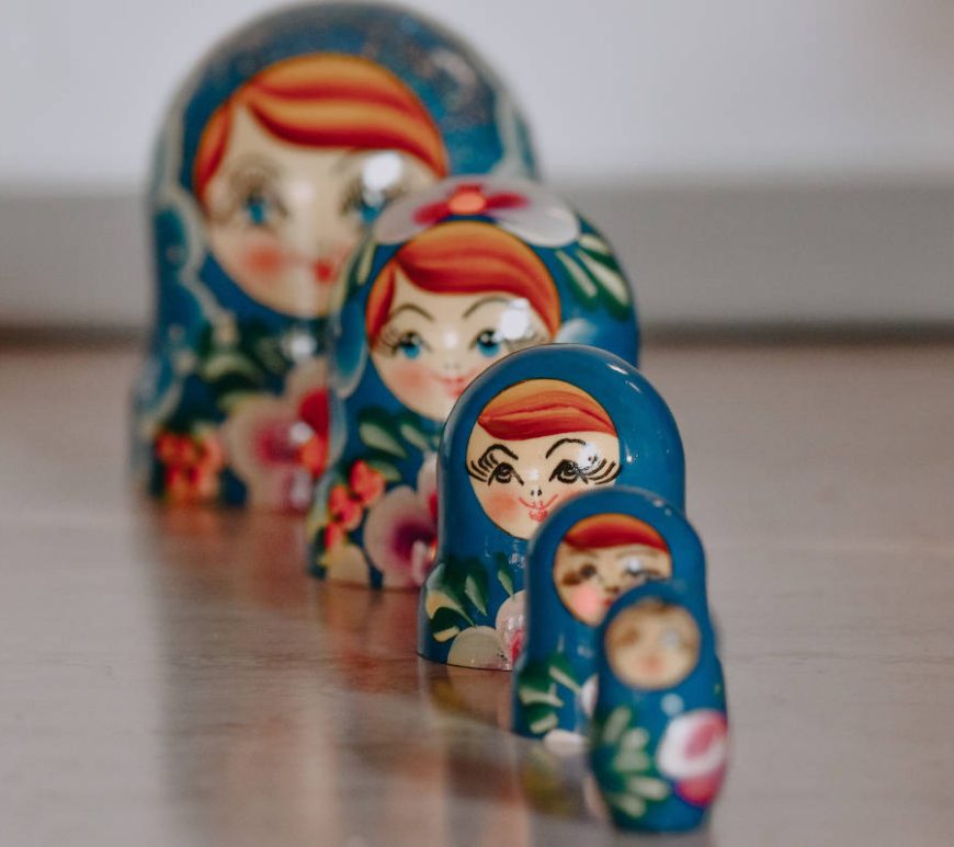 Five blue Matryoshka dolls, also known as stacking or nesting dolls.