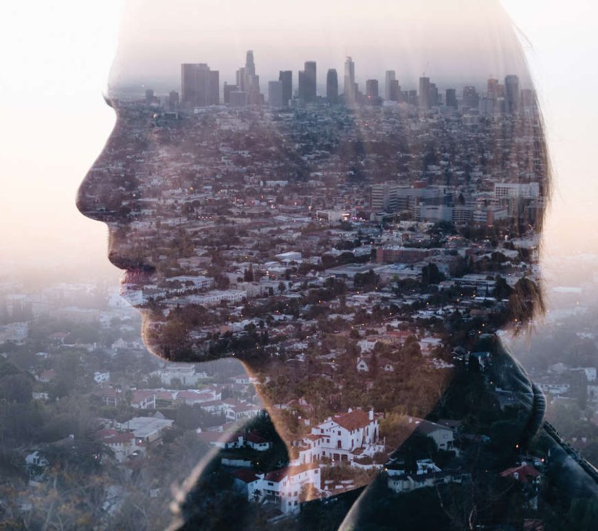 A young man's side profile as he gazes out into the distance, superimposed with a cityscape.
