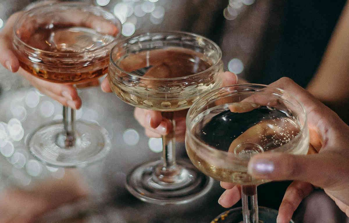 Toasting three cocktail glasses.